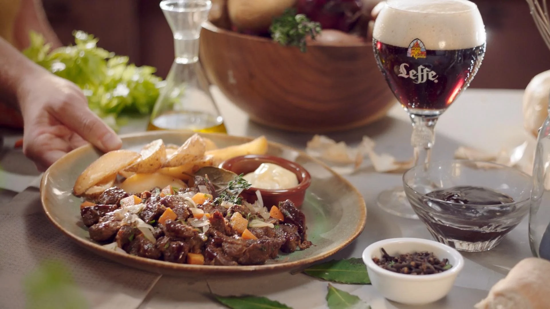 A plated dish served with a glass of Leffe
