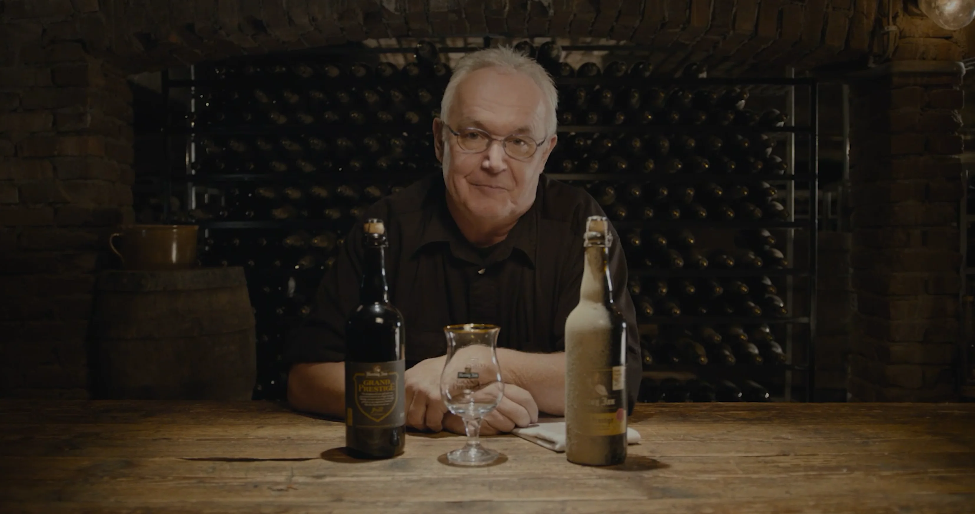 Masterbrewer Gerard at a cellar table with Grand Prestige bottles